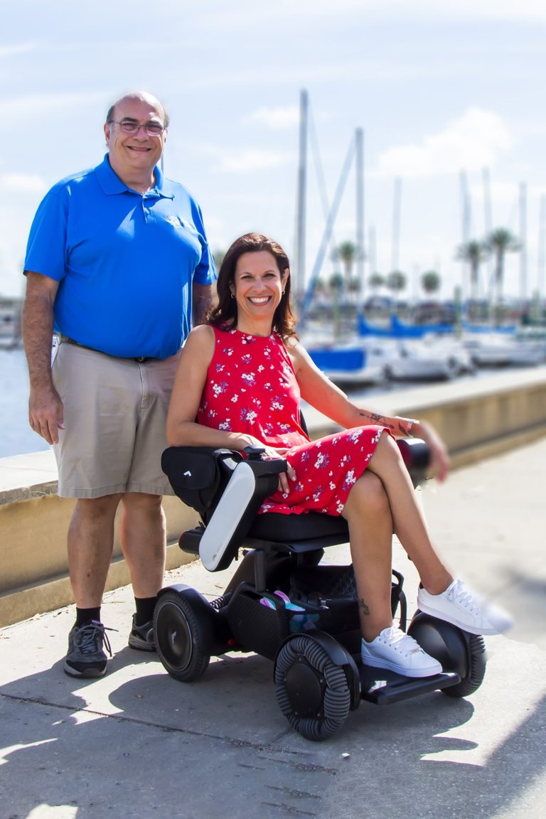 solo wheelchair traveler Sylvia meets the Sanford Mayor at the Sanford Riverwalk in Orlando North